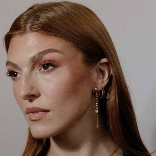 girl wearing bridal drop chain earrings and maroon bridal baguette hoop earrings ||all