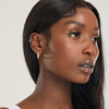 girl with 2 ear piercings wearing gold titanium bridal hoop earrings 