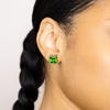 girl wearing green titanium stud earrings 
