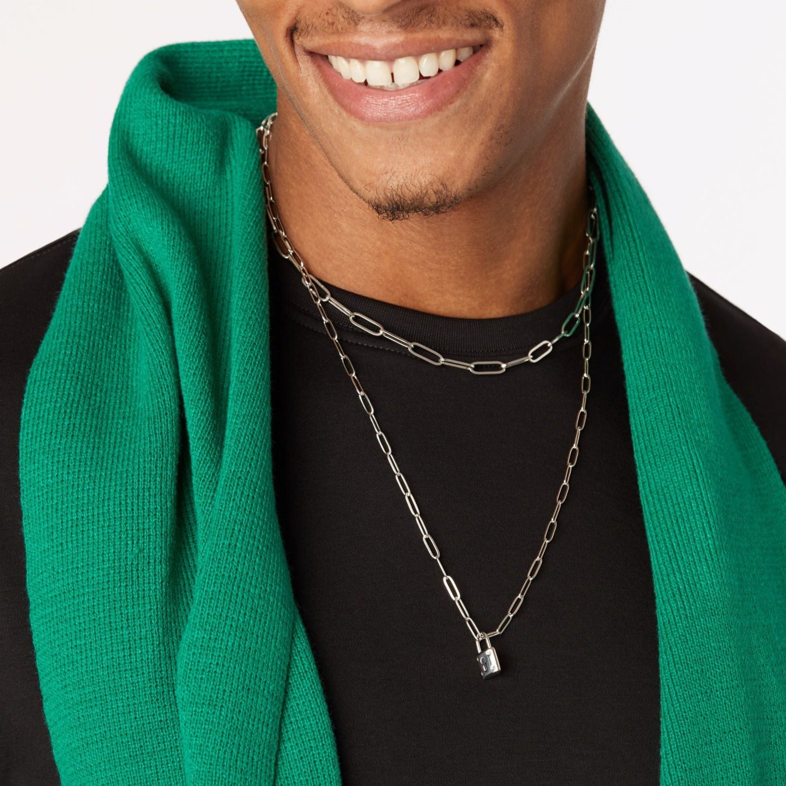 guy wearing green scarf and  silver titanium necklaces 